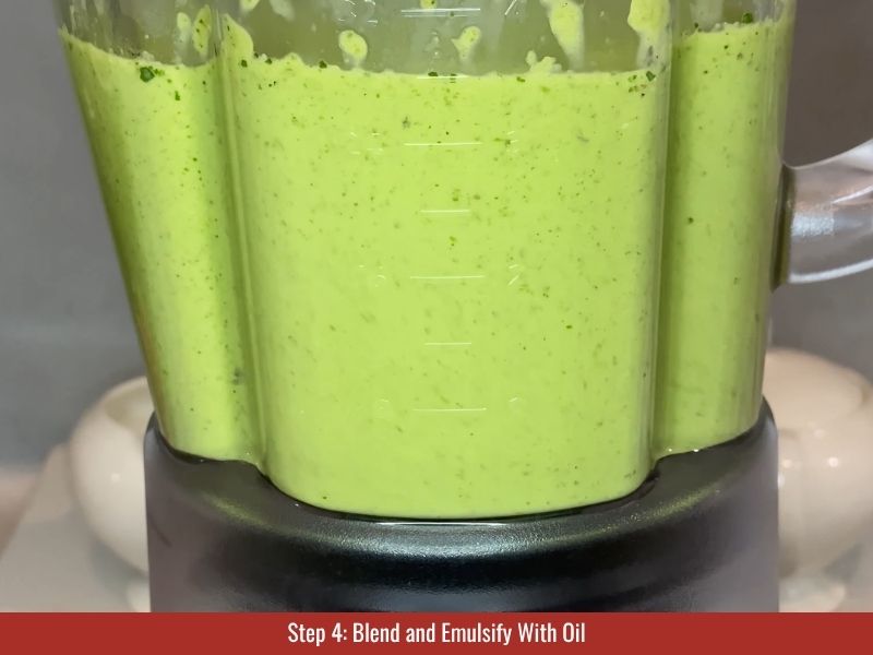 Blend while slowly streaming in oil until smooth, pale, and creamy, about 4-5 minutes.