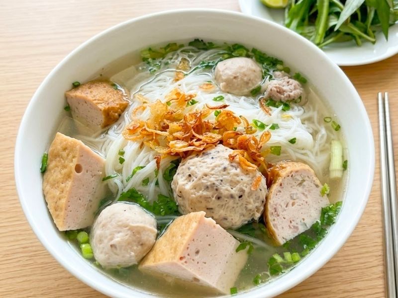 Bun moc with clear pork broth, springy pork meatballs, rice vermicelli, mushrooms, and herbs