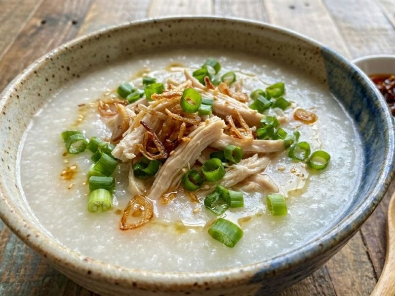 Vietnamese chao rice porridge with soft cooked rice, chicken, pork, fish, or traditional toppings