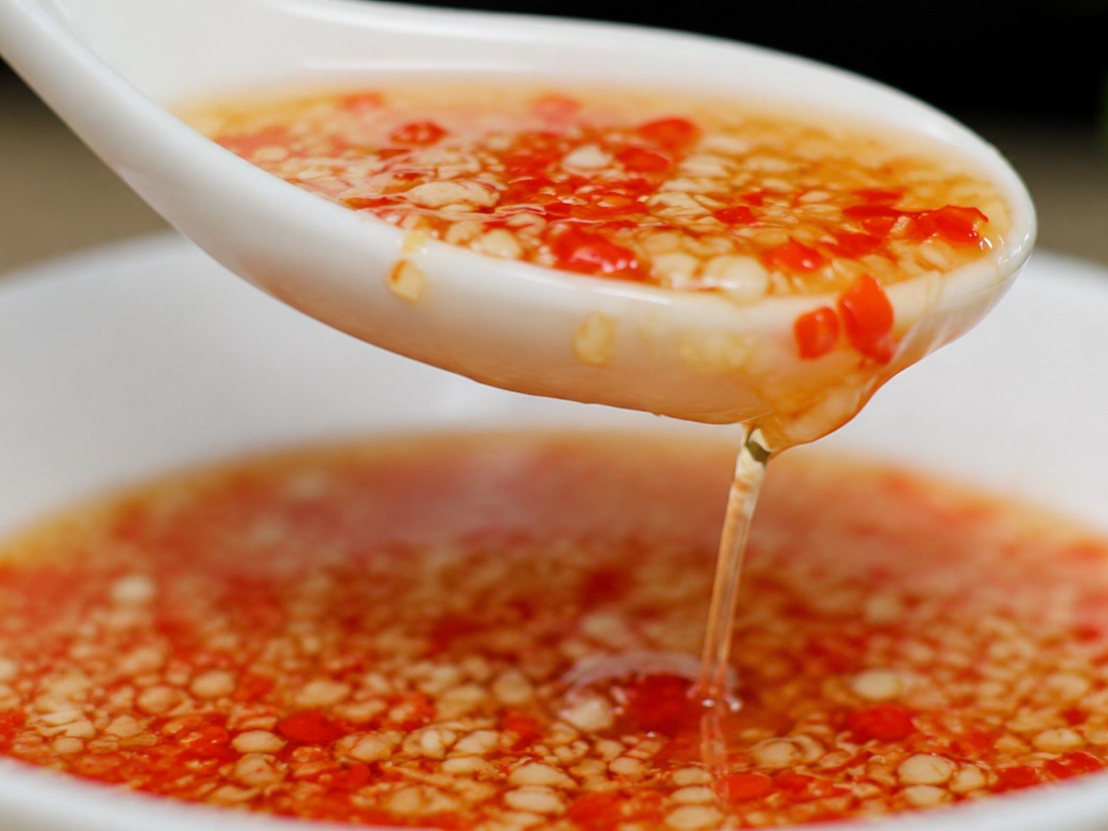 Finished bowl of nuoc cham with garlic and chili floating on the surface, ready to serve