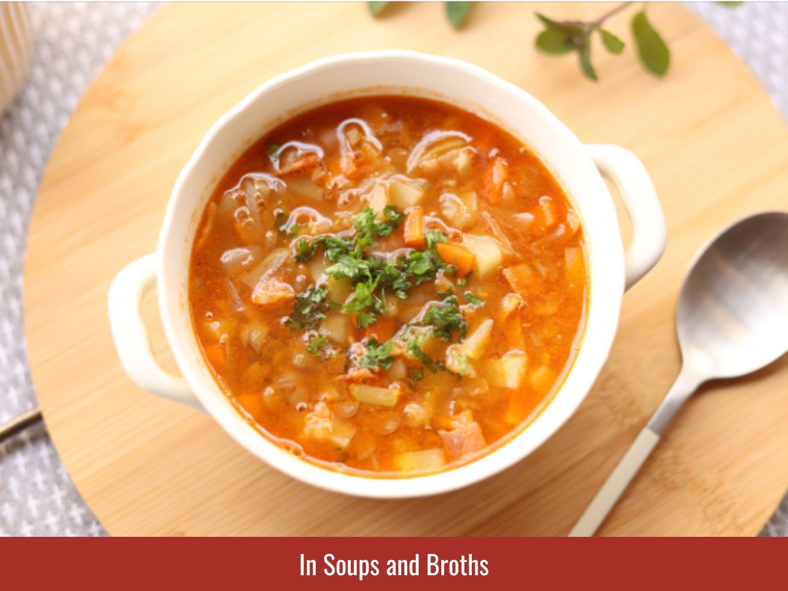 Bowl of savory soup topped with fresh chopped herbs