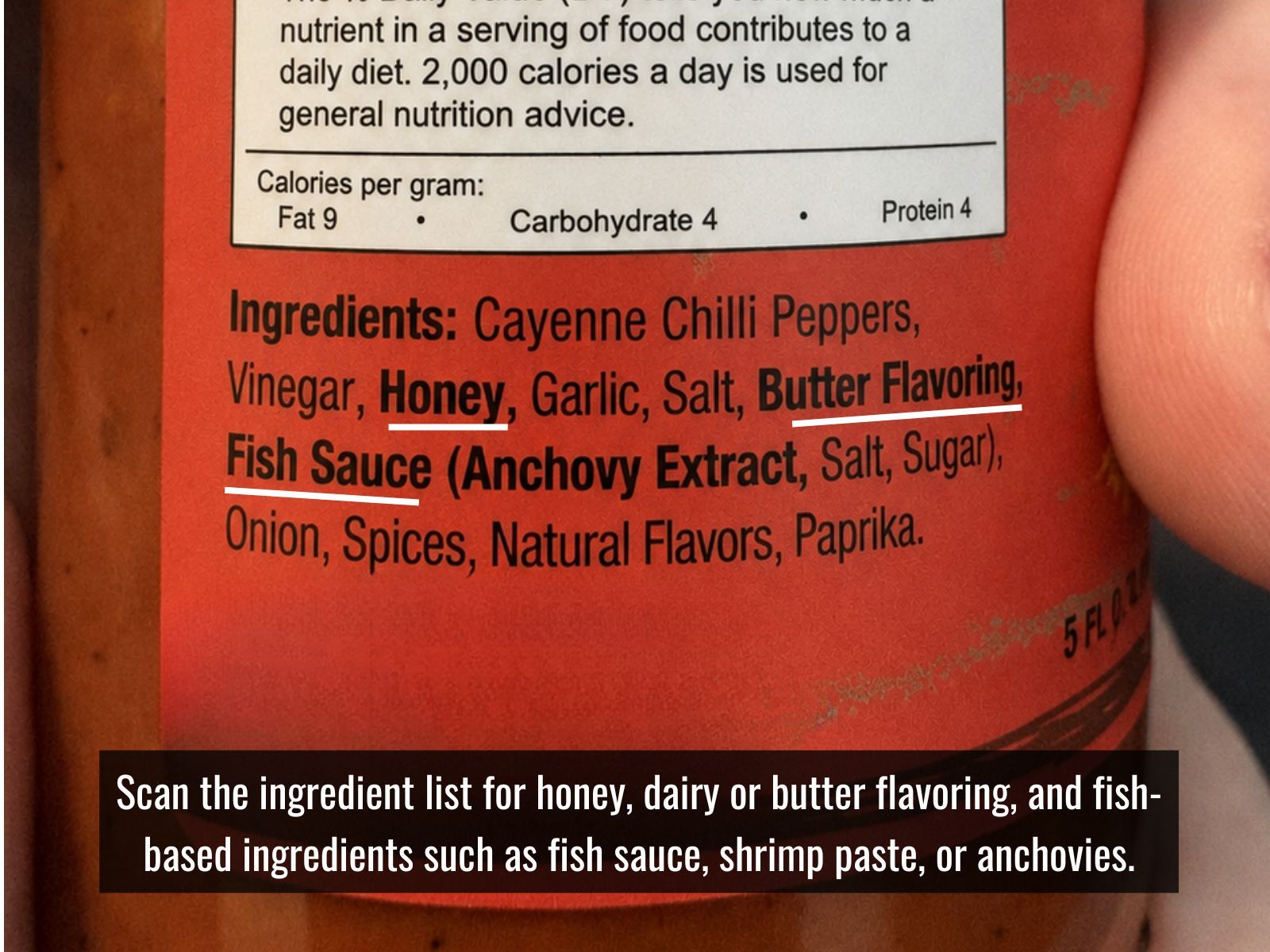Checking a hot sauce label for vegan ingredients and allergens