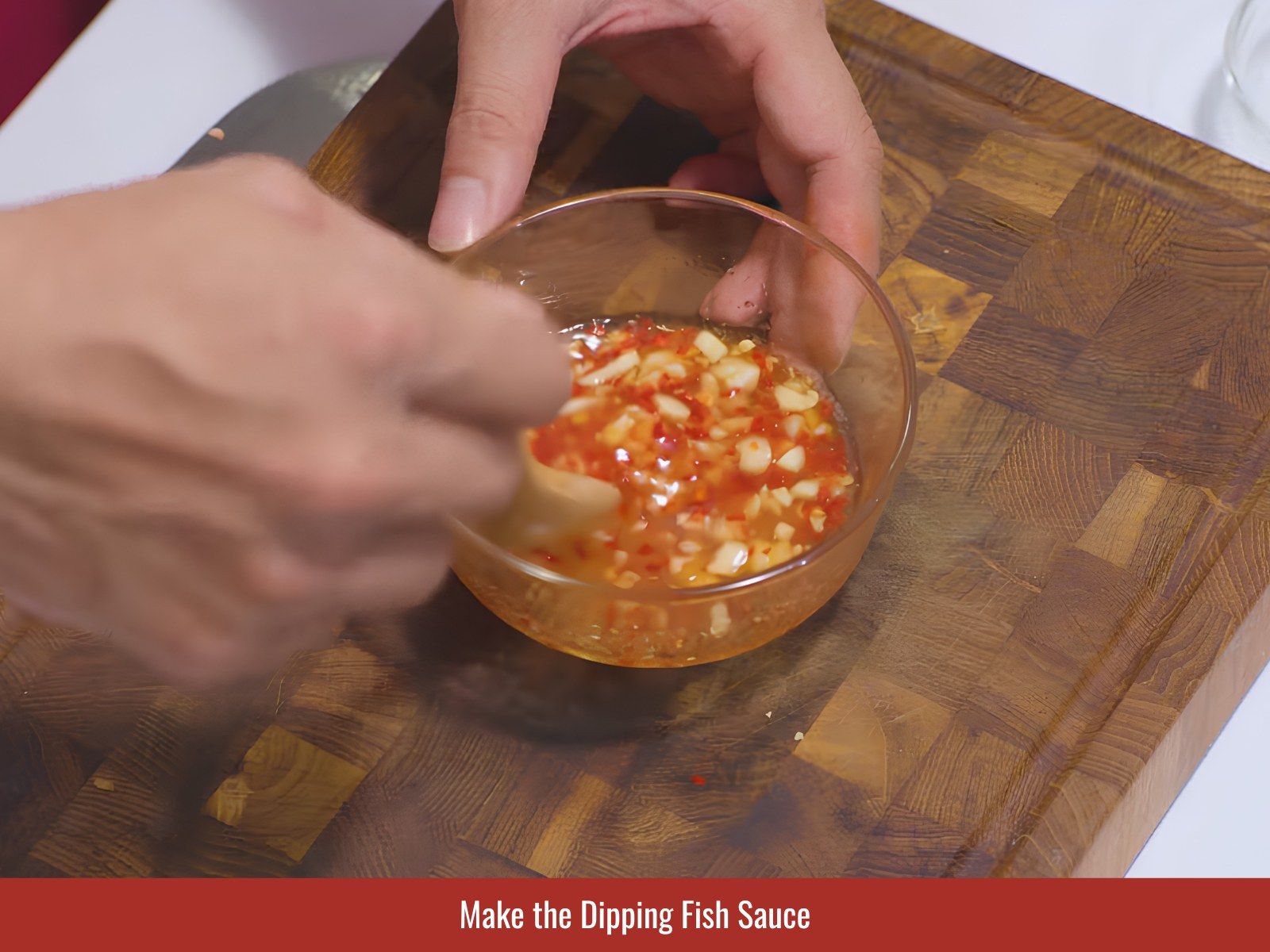 Mixing nuoc cham dipping sauce for vermicelli bowl