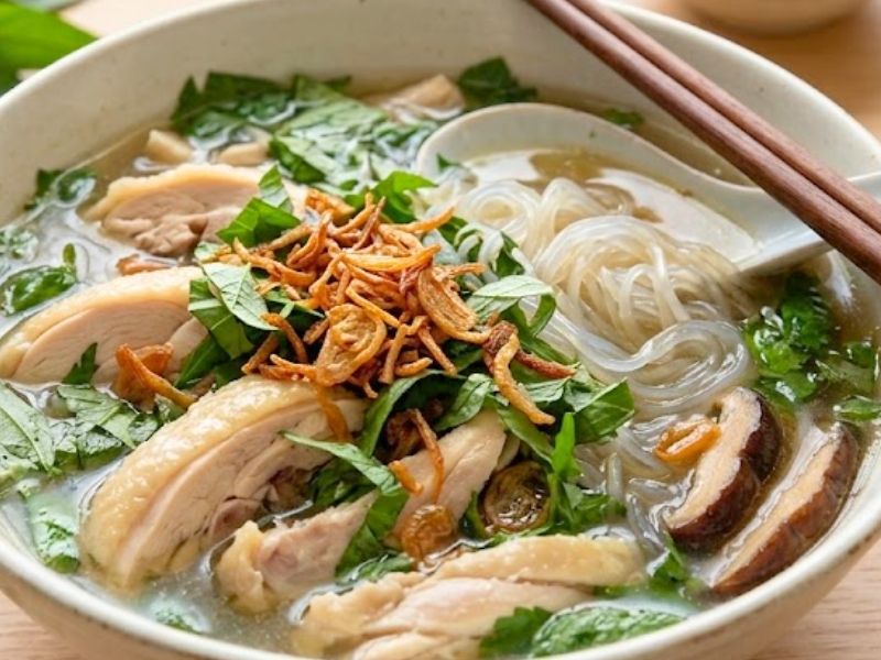 Vietnamese mien ga with glass noodles, shredded chicken, mushrooms, herbs, and clear broth