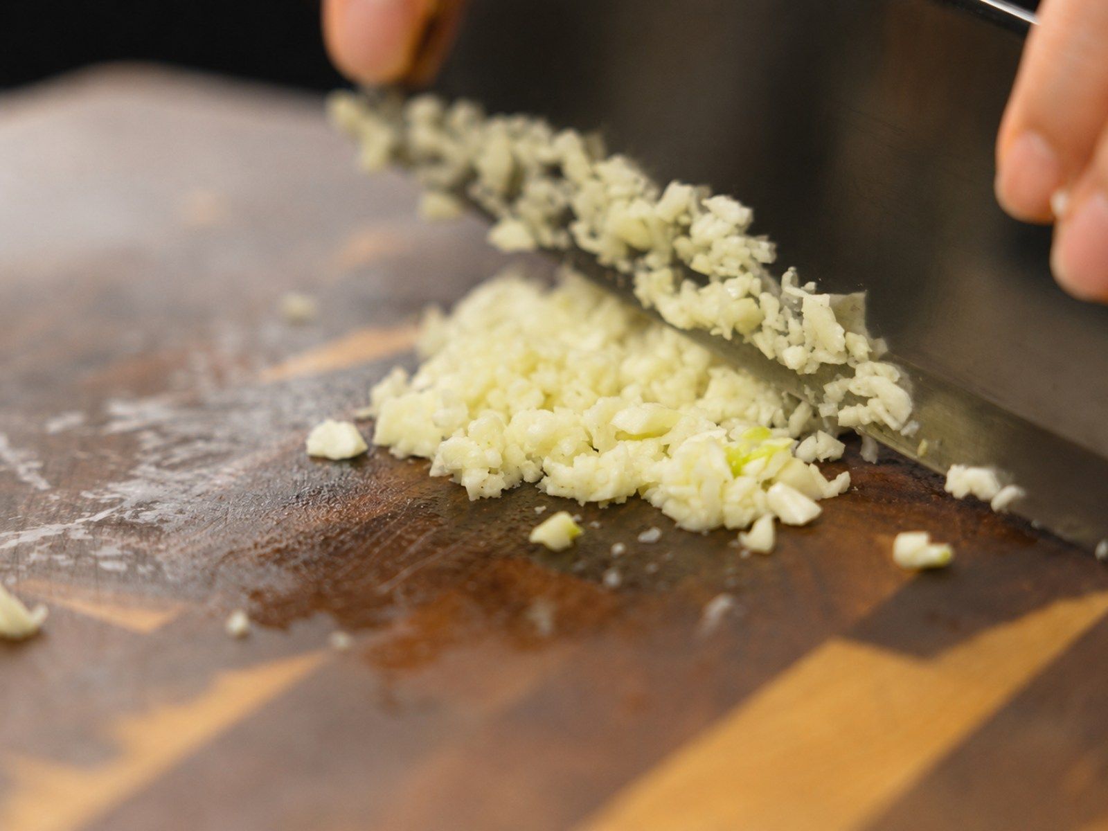 Finely minced garlic on a cutting board, prepared for nuoc cham