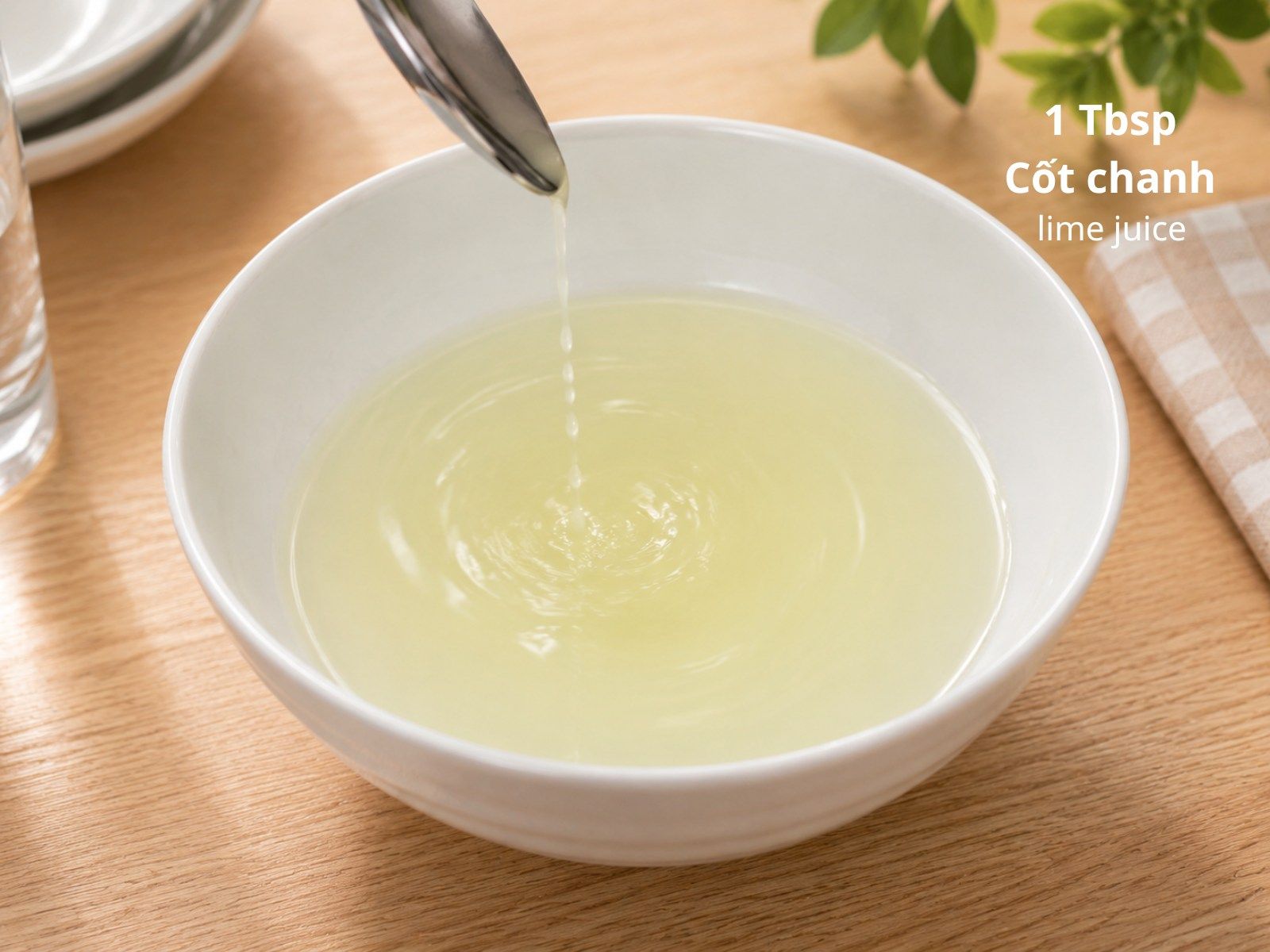 Fresh lime juice being added to the sugar water mixture in a bowl