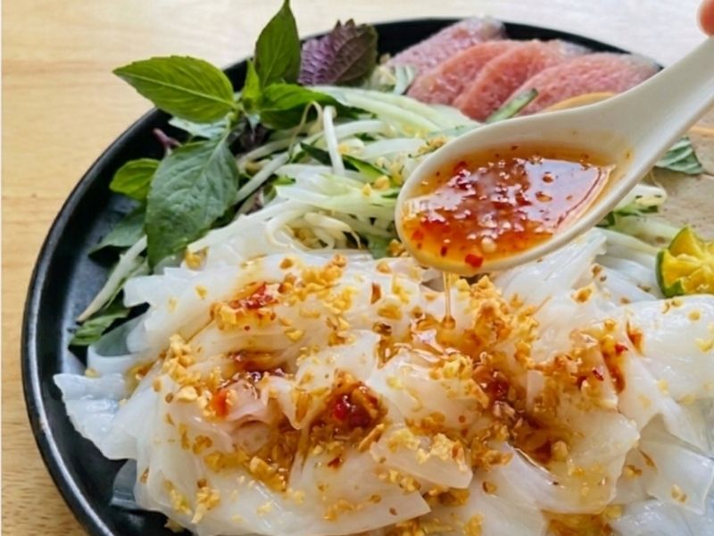 Serving banh uot with Vietnamese pork sausage, fried shallots, herbs, vegetables, and dipping sauce