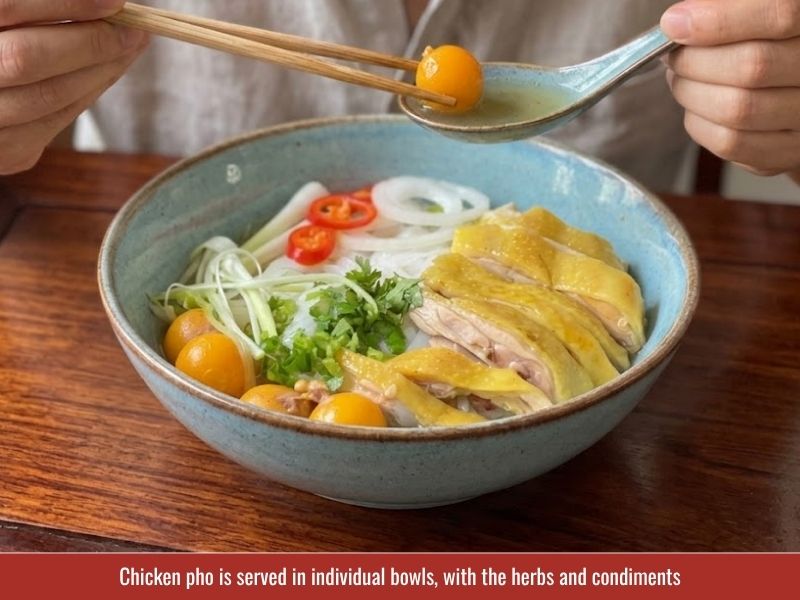 Serving chicken pho with fresh herbs, lime wedges, onion, chili sauce, and hoisin sauce