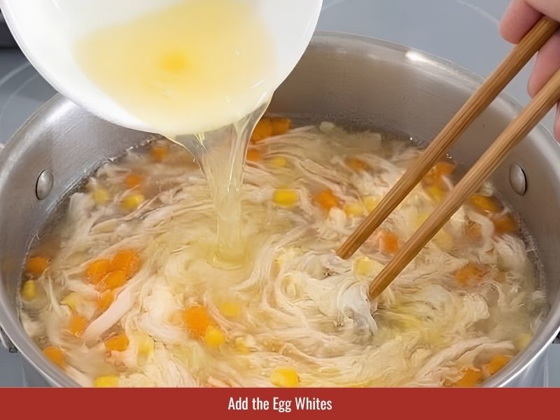 Adding egg whites slowly to create visible egg ribbons in Vietnamese crab soup