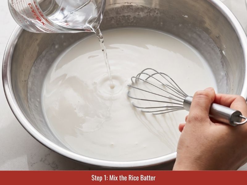 Mixing rice flour and tapioca starch with water to prepare thin banh cuon rice sheet batter