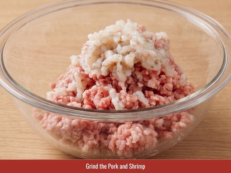 Grinding pork and shrimp to prepare a finely textured cha gio filling