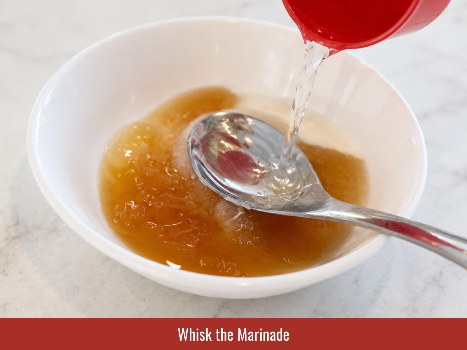 Whisking fish sauce soy sauce sugar lime and aromatics