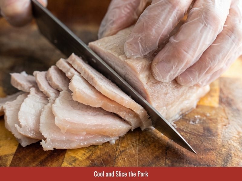 Slicing cooled pork belly into thin pieces for crispy Vietnamese pancakes