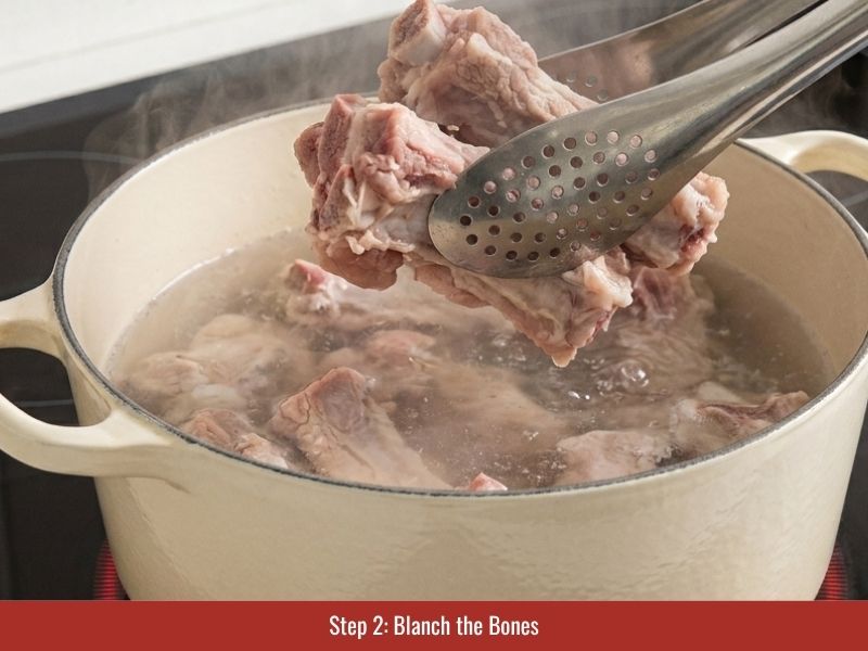 Blanching chicken bones and rinsing them to create a clearer chicken pho broth