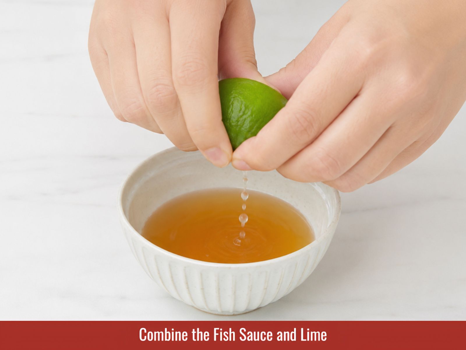 Combining fish sauce and fresh lime juice in a bowl