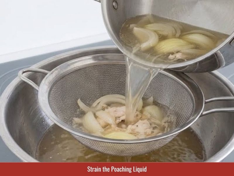 Straining clear chicken broth before combining ingredients for Vietnamese crab soup