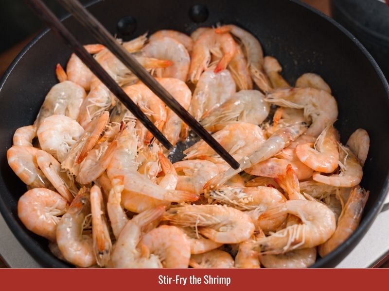 Stir-frying shrimp with seasoning before adding to the banh xeo filling