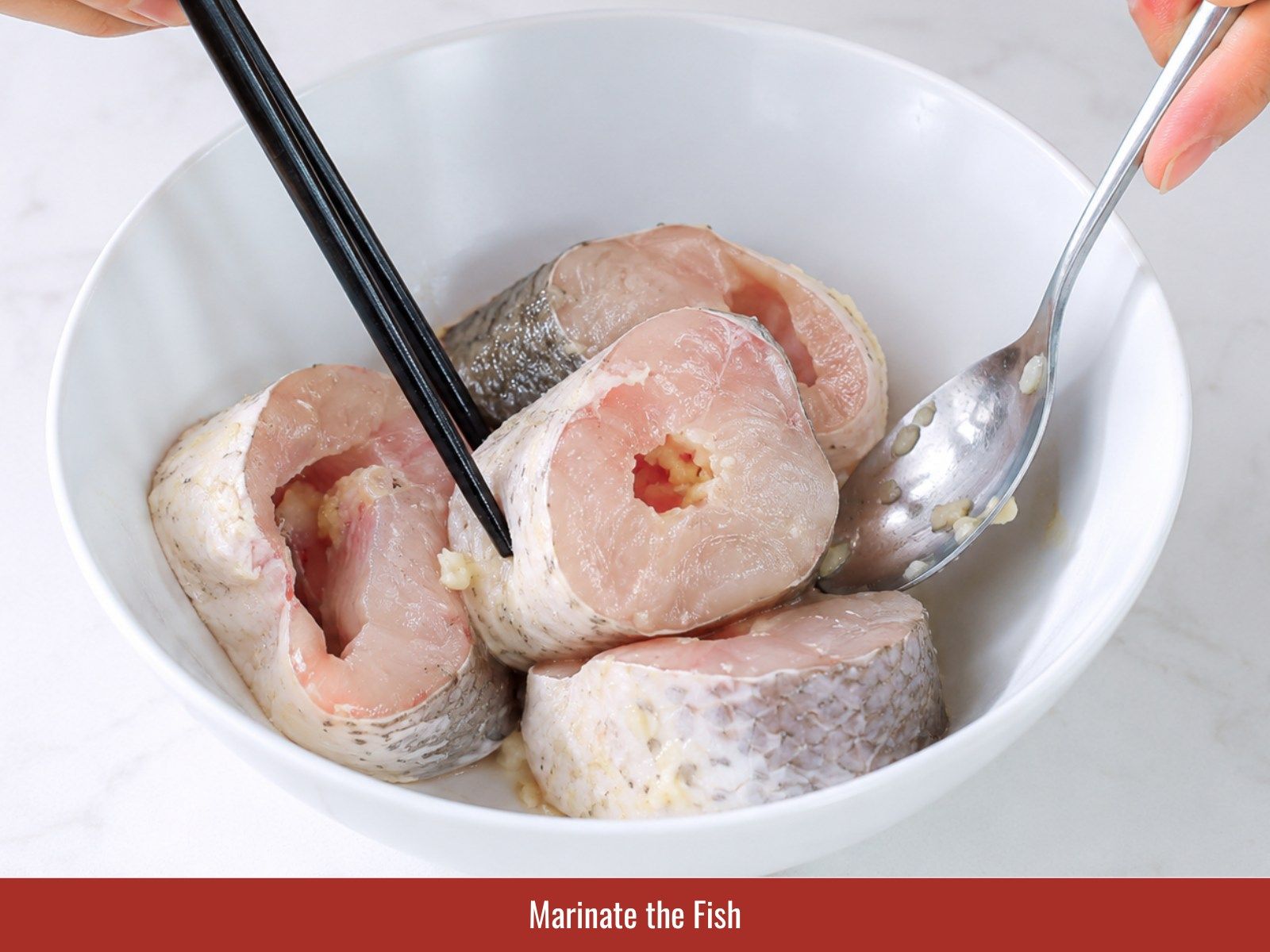 Marinate fish with fish sauce, garlic, and bouillon