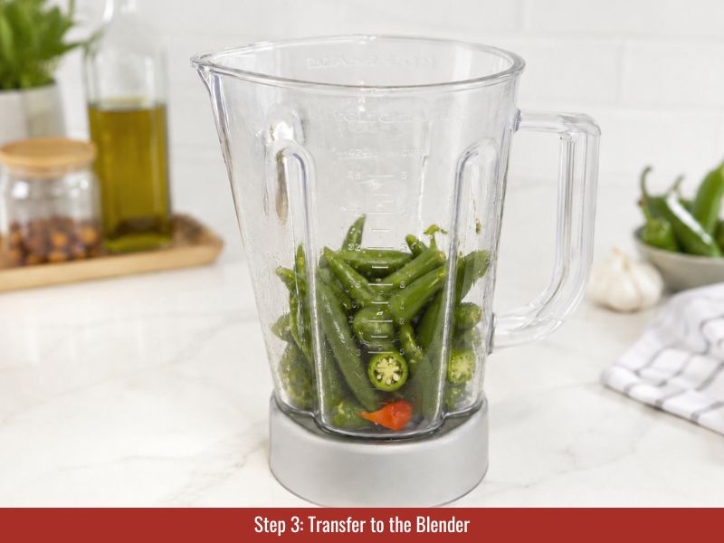 Transfer roasted serrano peppers to blender