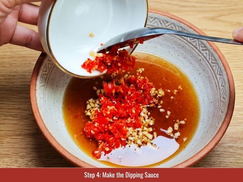 Preparing Vietnamese nuoc cham with fish sauce, sugar, lime juice, garlic, and chili