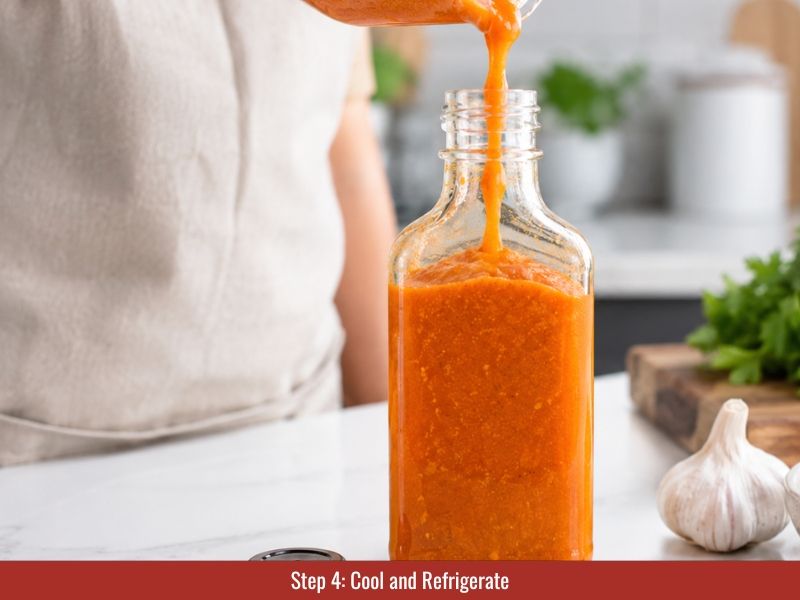 Finished datil pepper hot sauce poured into clean glass bottle