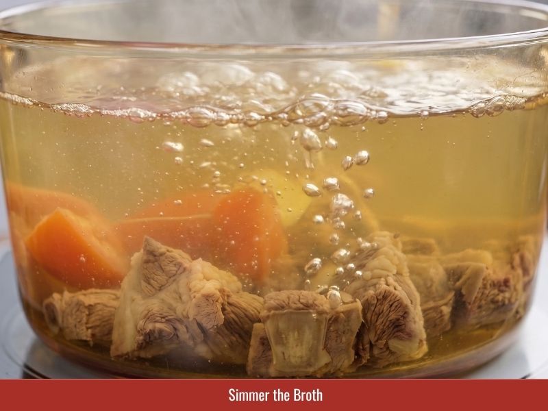 Simmering pork ribs with vegetables and aromatics to build clear Vietnamese soup broth