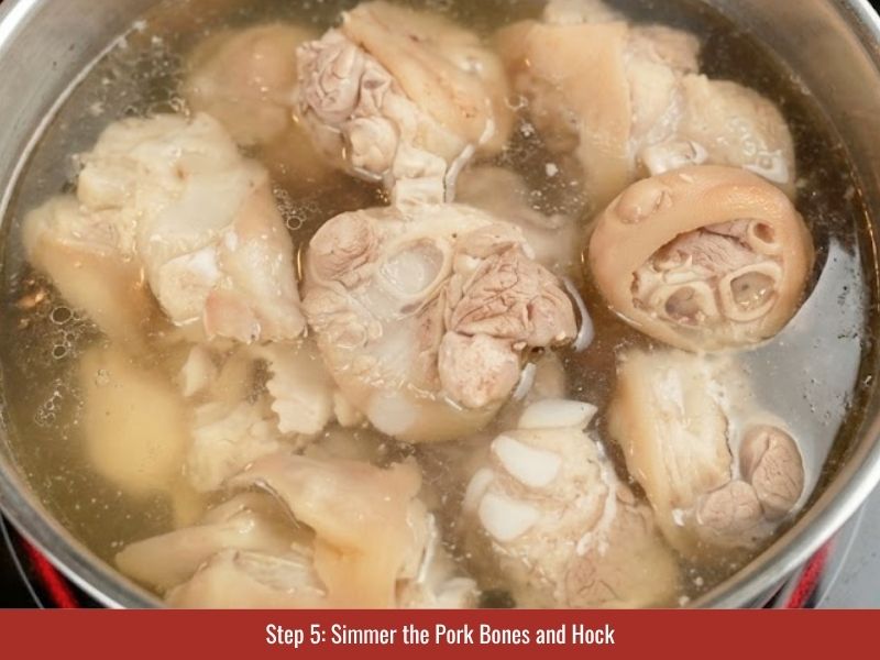 Simmering pork bones and pork hock to build a rich collagen-filled broth for bun bo Hue