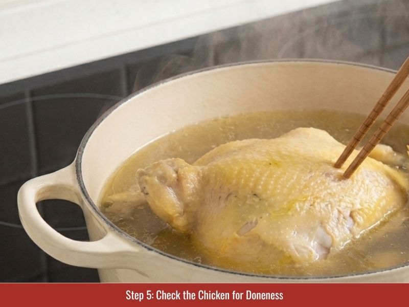 Checking poached chicken temperature and texture before removing it from the broth