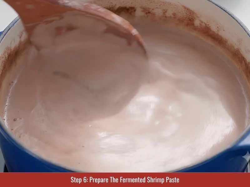 Preparing fermented shrimp paste liquid to add traditional savory depth to bun bo Hue broth