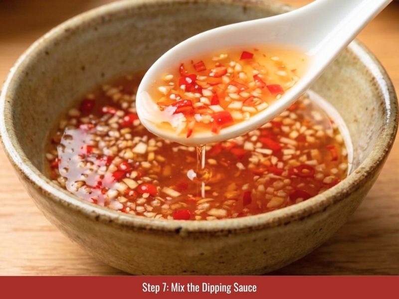 Preparing Vietnamese nuoc cham with fish sauce, sugar, lime juice, garlic, and chili