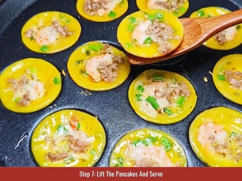 Removing cooked banh khot from the molds and serving with herbs and dipping sauce