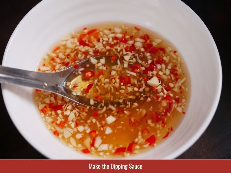 Preparing banh xeo fish sauce dipping sauce with lime, sugar, garlic, and chili