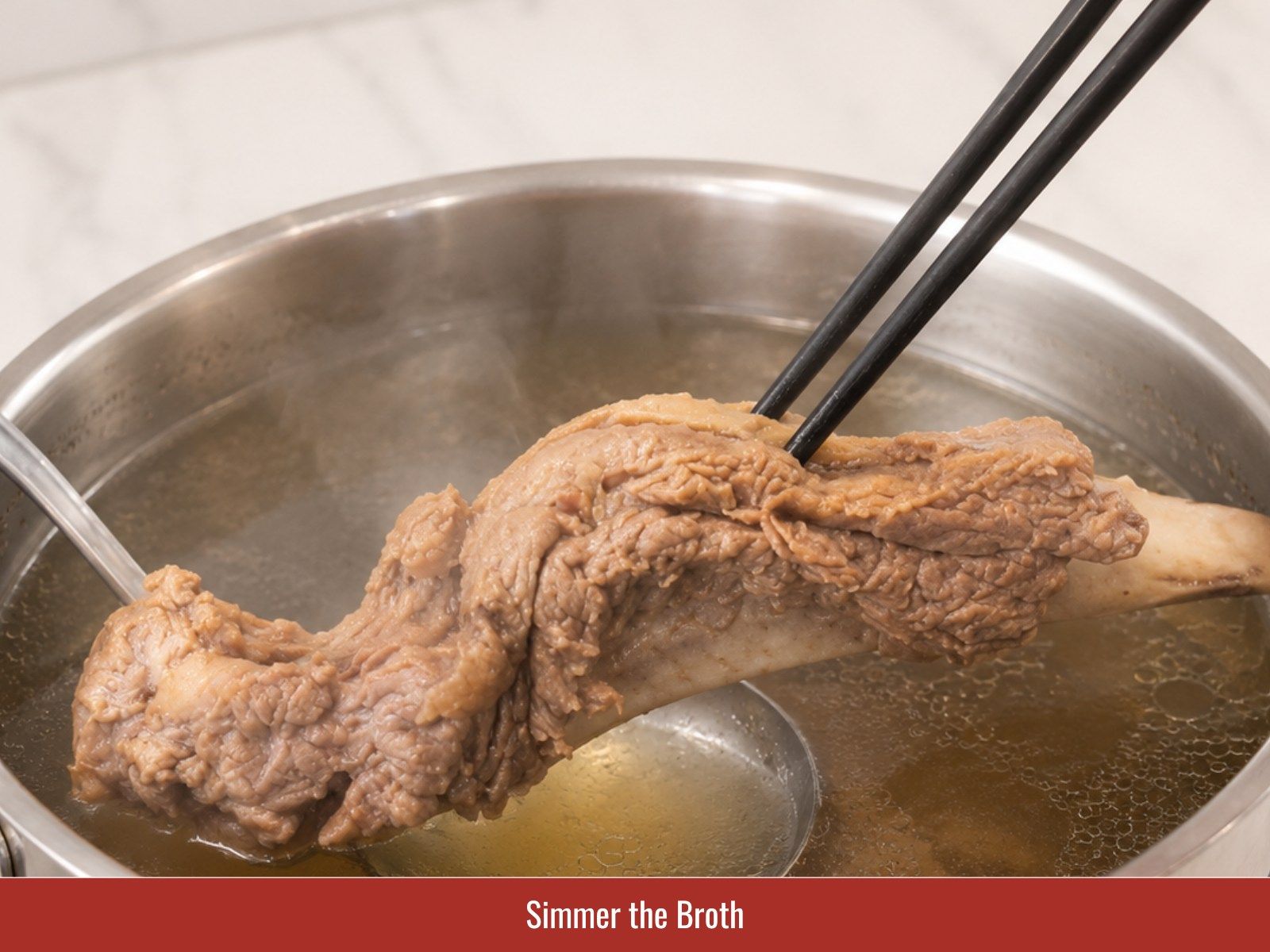 Simmer beef rib pho broth gently