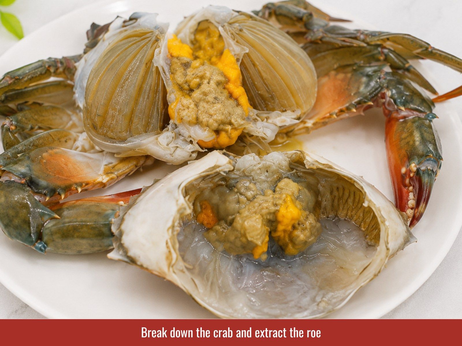 Clean crab, remove roe, and cut crab