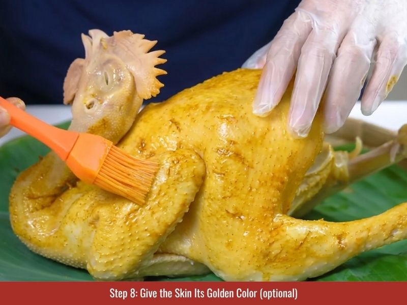 Applying optional turmeric coloring to chicken skin for a golden appearance