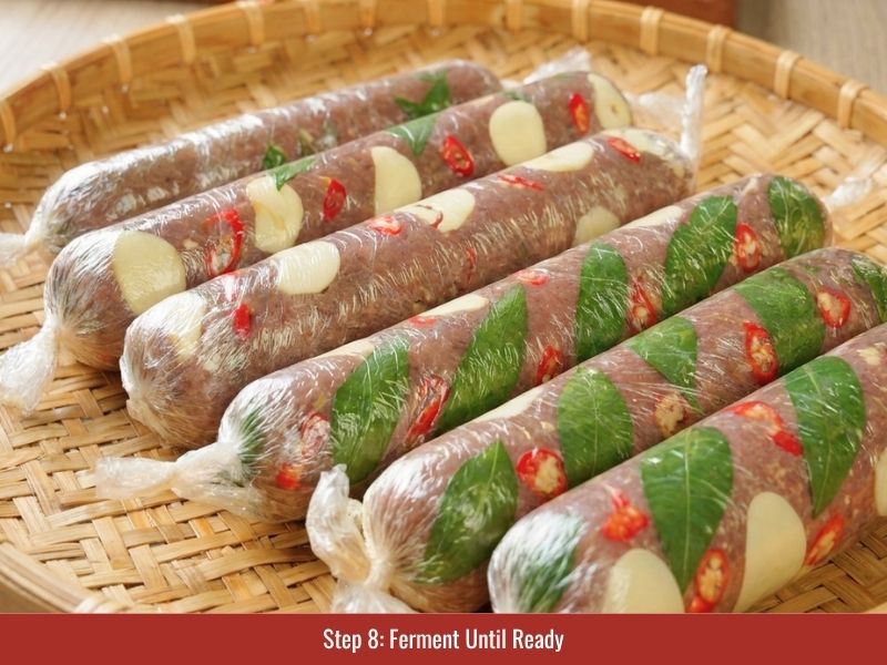 Fermenting wrapped nem chua until the meat develops sour flavor and firm texture