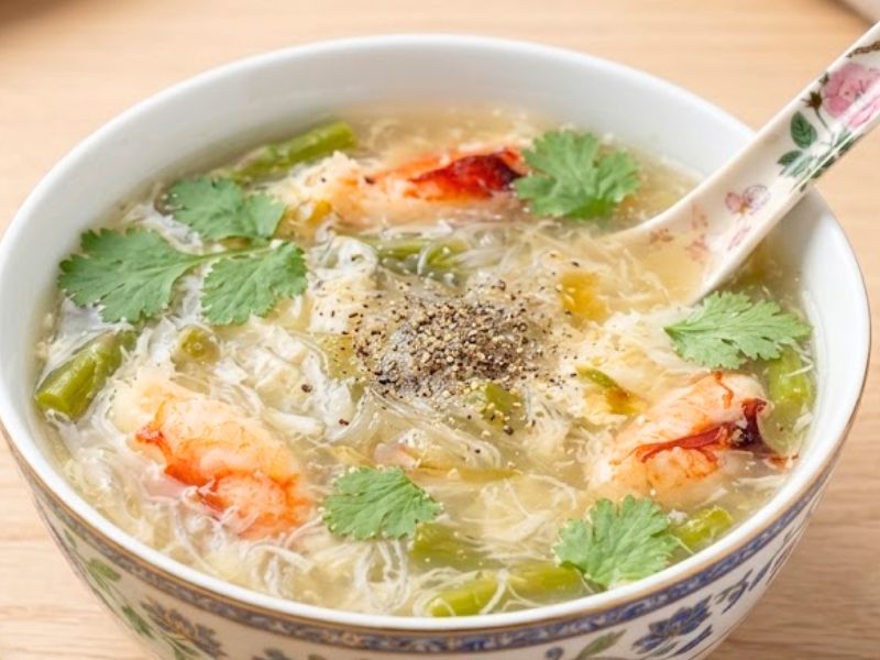 Vietnamese sup mang cua with crab, asparagus, chicken broth, quail eggs, and silky thickened soup