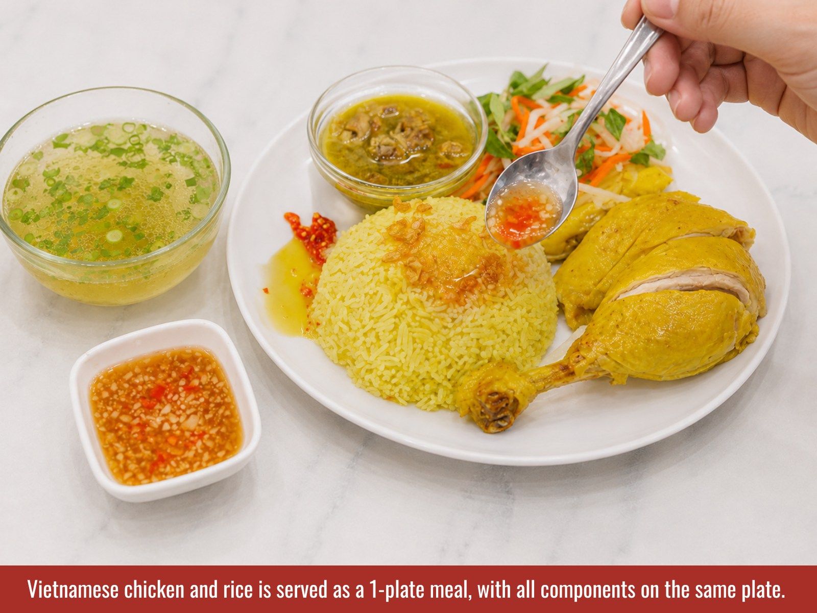 Serve Vietnamese chicken and rice with turmeric rice, chicken, salad, and sauces