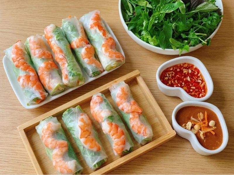Fresh Vietnamese spring rolls filled with shrimp, pork belly, rice noodles, lettuce, herbs, and served with peanut sauce